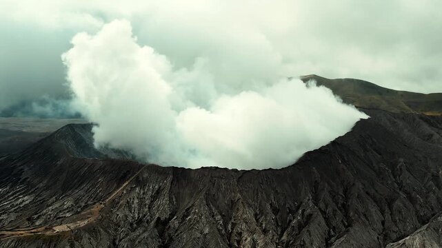Drone overview of massive white plume rising from Mount Bromo crater, East Java, Indonesia