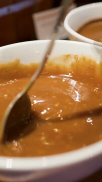 Stirring Creamy Asian Sesame Dipping Sauce in a White Bowl