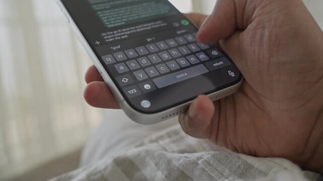 Man hands chatting and typing on smartphone macro closeup. Unrecognisable human typing text message tapping touchscreen keyboard using WhatsApp application, a social media.