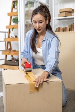 Ecommerce, packing, shipping, fulfillment, small business owner carefully placing ceramic bowl into cardboard parcel box, preparing product for safe shipment while managing home warehouse workflow.