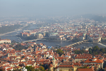 Obraz premium Panoramic aerial view of Charles Bridge over Vltava River and Old Town red roofs, Prague, Czechia. g.
