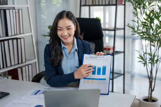 Smiling young businesswoman presenting financial data online