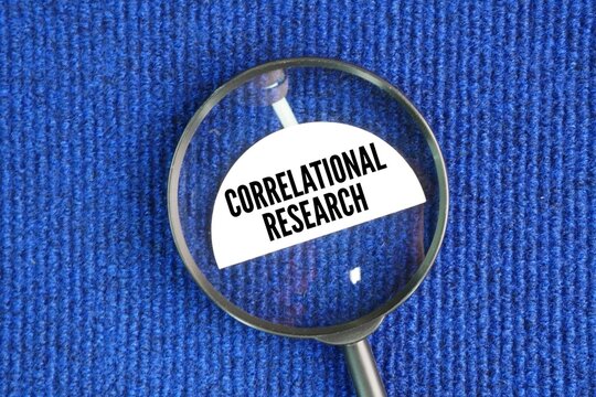 Magnifying glass with the word Correlational research is a non-experimental method that measures the statistical relationship between two or more variables without manipulating them