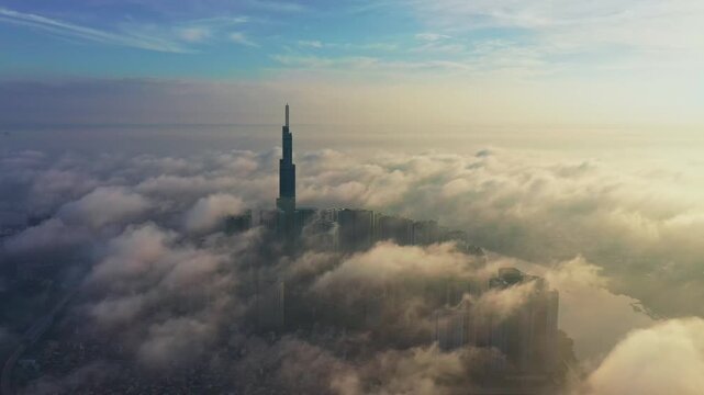Cinematic aerial view of Landmark 81 above the clouds at sunrise, Saigon Skyline, Vietnam