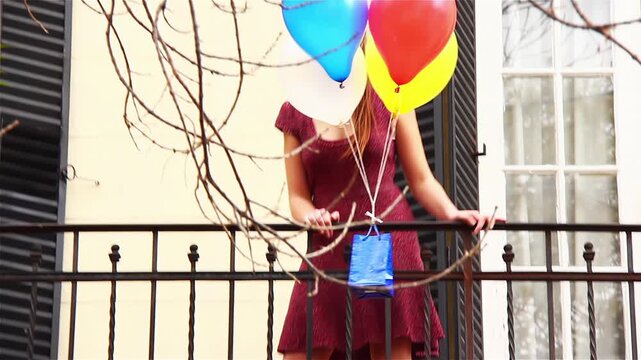 Surprise Romantic Delivery: Colorful Balloons And Gift Bag Floating Towards A Woman - 4K