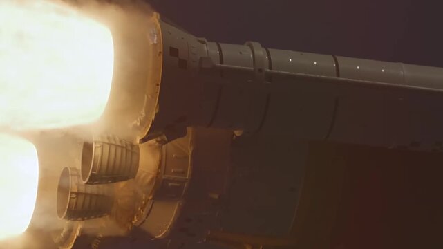 Close up view of a rocket engine during launch showing intense fire and smoke exhaust.