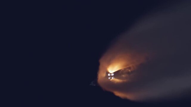 Rocket booster separation and stage ignition during space mission launch.