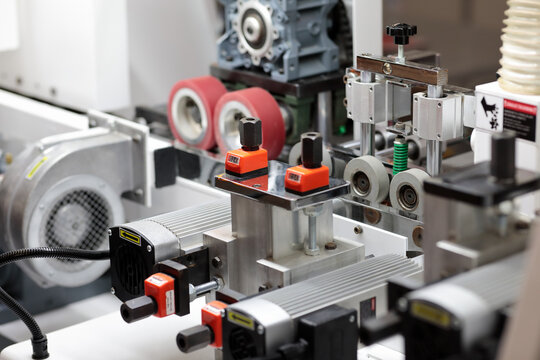 closeup of industrial chipboard processing machine