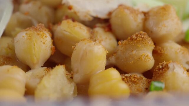 Close-up of Seasoned Chickpeas with Spices and Fresh Vegetables
