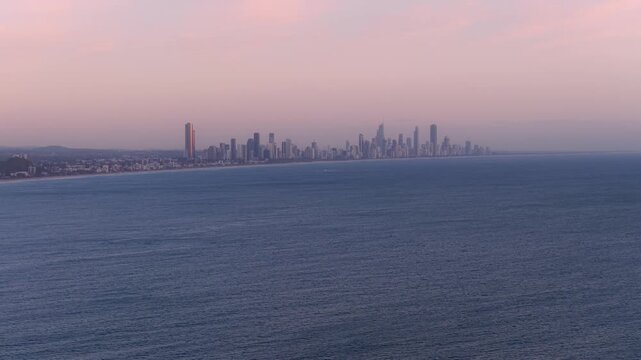Surfers Paradise Skyline In Gold Coast, QLD, Australia - Towering Buildings Against Sunset Sky With Pacific Ocean In Foreground. wide drone shot