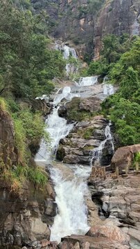 Kuda Ravana Falls Ella Sri Lanka jungle cascade flowing stream tropical hillside