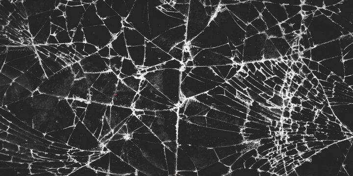 An intricate pattern of broken glass or a cracked screen. The contrasting white crack lines against the dark background create a dramatic, sharp, and textured visual.