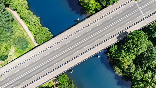 Aerial drone view of bridge over river, forest landscape and modern road bridge, transportation and infrastructure concept, the Netherlands