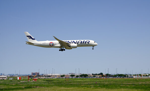 Finnair aircraft Airbus A350-900, Santa Claus Finland sticker, landing at Dallas Fort Worth International Airport (DFW) from Helsinki. Blue skies.