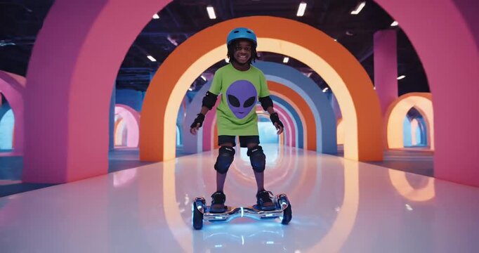 Kid Riding Electric Scooter Through Arches.