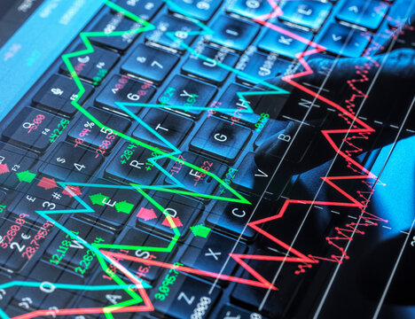 City trader analyzing volatile stock market graph on computer