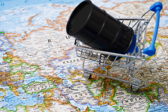 Black oil drum in a shopping cart on a world map showing Iran