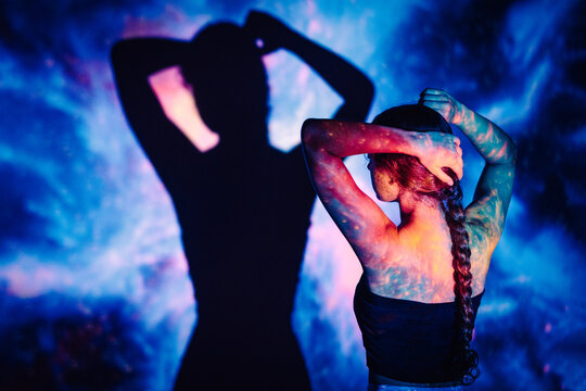 Space galaxy projection and shadow in a studio portrait
