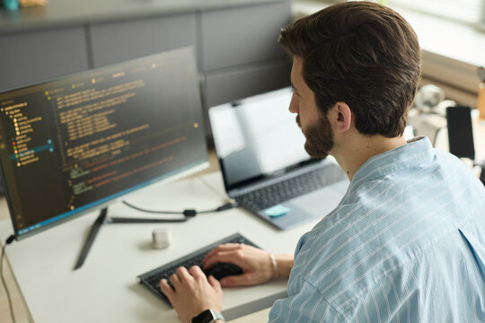 Programmer coding on computer in the office