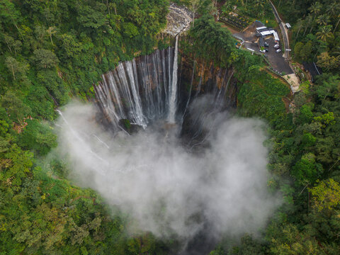 Aerial view of Tumpak Sewu Waterfall in the lush jungle of Java