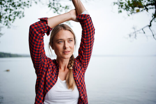Beautiful woman with arms raised looking away