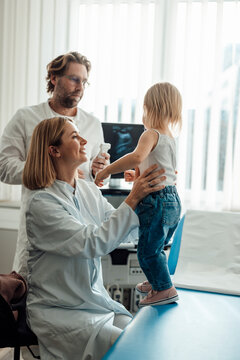Doctors examining child during medical checkup in clinic