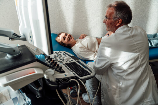 Doctor performing an ultrasound on a pregnant patient in a clinic