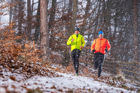 Trail running training in snowy winter forest in Haselstein Remstal Germany
