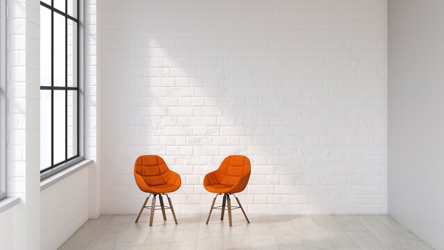 Two orange chairs in a bright modern white loft waiting area