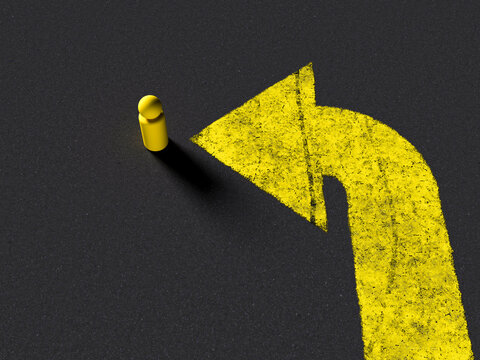 Yellow game piece and direction arrow on dark asphalt