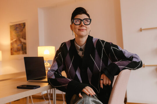Smiling creative director thinking at the office desk