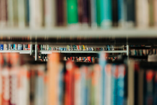 Colorful books on library shelves with selective focus