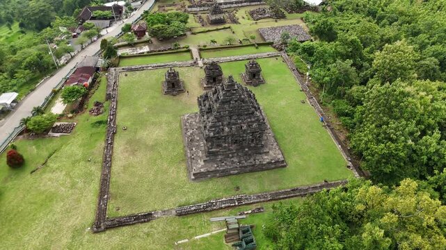 Bird's eye view of Candi Ijo temple architecture with smooth orbit motion in overcast weather