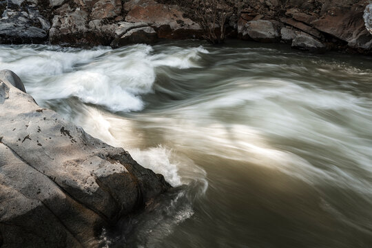 water flowing over rocks on lake