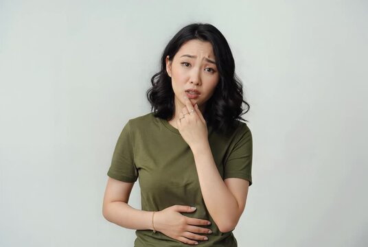 Asian Woman Feeling Unwell with Stomach Ache and Nausea Isolated on White