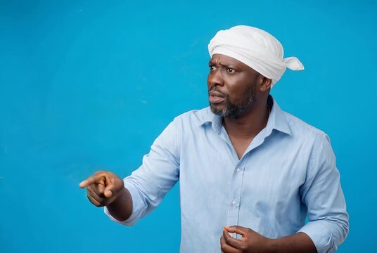Middle Aged African Man Pointing Accusatory Finger with Surprised Expression
