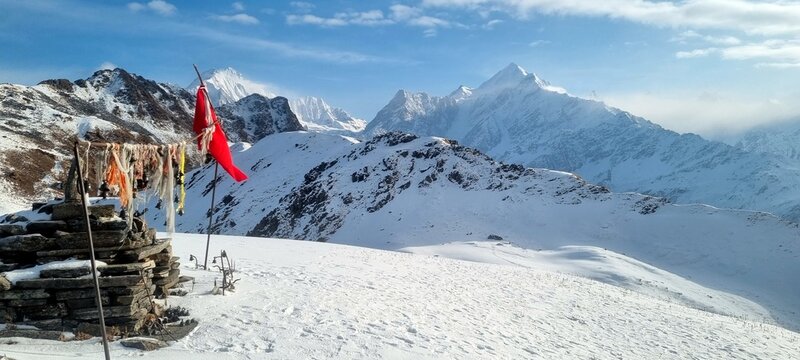 Snowy Nagni Dhura pass with distant Himalayan peaks in Uttarakhand