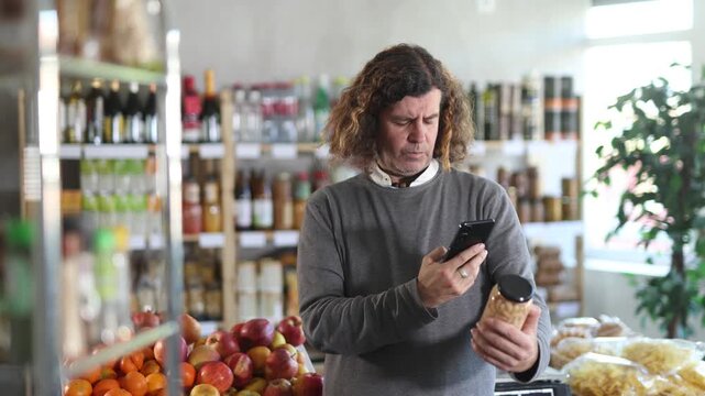 European scans the barcode on a can of beans, reads the composition of the product, calorie content and expiration date. High quality 4k footage