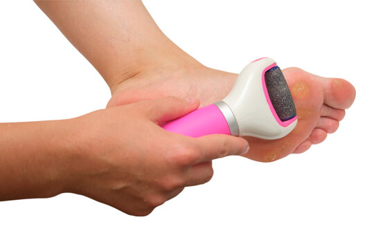 Woman using electric foot file to remove callus from sole. Pedicure device for smooth skin care and hygiene. Isolated transparent background shot of home spa treatment. Beauty concept.
