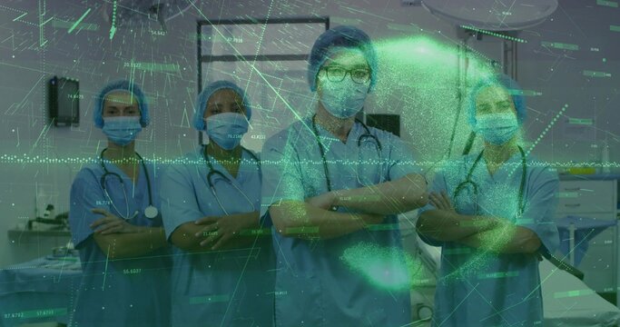 Standing team wearing blue scrubs, caps, masks with stethoscopes in OR showing AR data