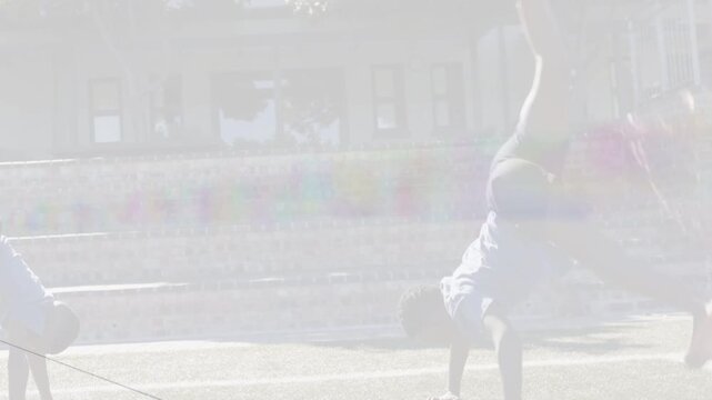 Two male athletes initiating handstands and cartwheels by planting hands, training fitness in plaza