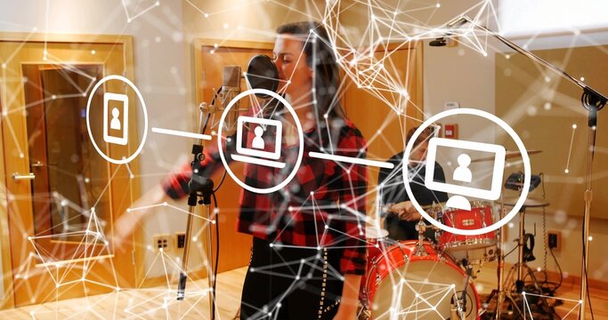 Singing singer in studded skirt gesturing and recording in studio with mic and network overlay