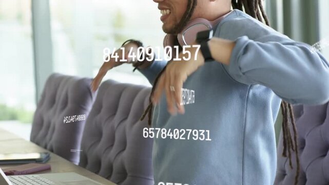 Man reacting to laptop data overlay, stretching, adjusting headphones, leaning in, typing for tech