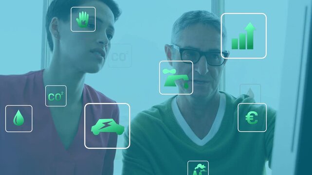 Floating green icons appearing, colleagues leaning and pointing at monitor, analyzing climate data