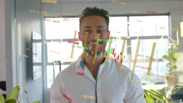 Male worker standing facing camera as finance charts animating across torso, smiling at gains