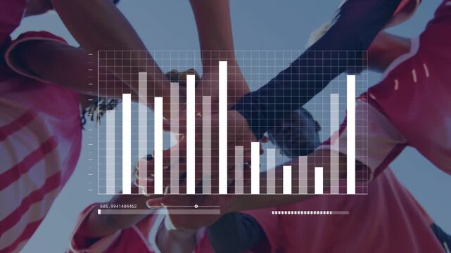 Male sports team stacking hands and extending arms in huddle for kickoff, driving analytics HUD