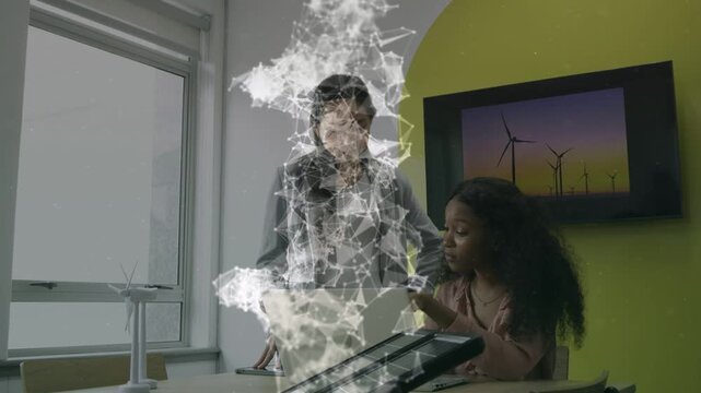 Lead tapping laptop, seated peer following as mesh overlay and turbine screen guiding energy demo