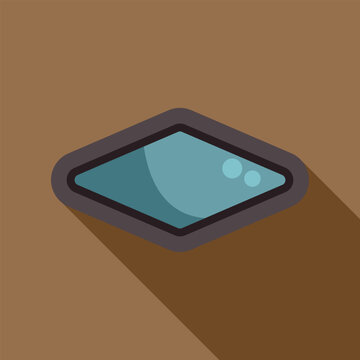 Diamond shape window with blue glass creating a long shadow on brown background