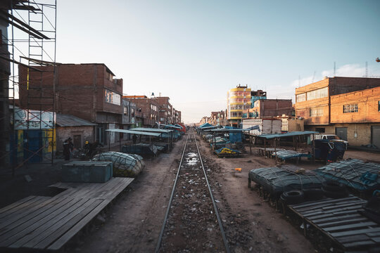 A train passing directly through the central local market in Juliaca, Peru, on the route between Cusco and Puno.