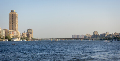 Cairo skyline and Nile River with residential towers and boats © Dewald